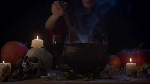 Hand mixing with spoon something in steaming cauldron Stock Footage 141293032