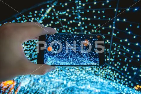The hand with mobile camera shot bright lights Stock Photos