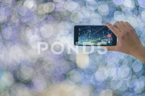 The hand with mobile camera shot bright lights Stock Photos
