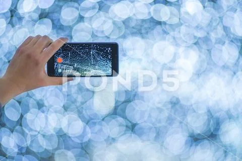 The hand with mobile camera shot bright lights Stock Photos