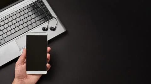 Hand on a mockup digital device personal computer and headphones Stock Photos