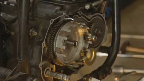 A hand of motorcycle mechanic assembling clutch assembly Stock Footage 78223133