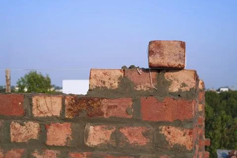 Hand-moulded brickwork with a string or thread line level for masonry. Close-up. Stock Photos
