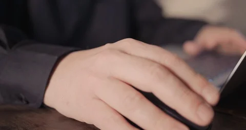 Hand on the mouse and another hand typing Stock Footage 119673835