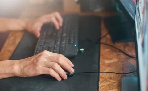 Hand on mouse. Businessman use computer pc on night time Stock Photos