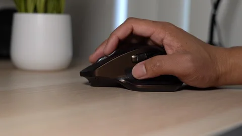 Hand on mouse clicking and scrolling Stock Footage 102509580