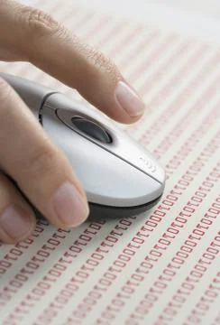 Hand on mouse with computer code Stock Photos