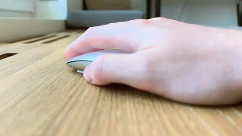 Hand on a mouse viewed from the thumb side. Fingers clicking on a wooden de.. Stock Footage 340283848
