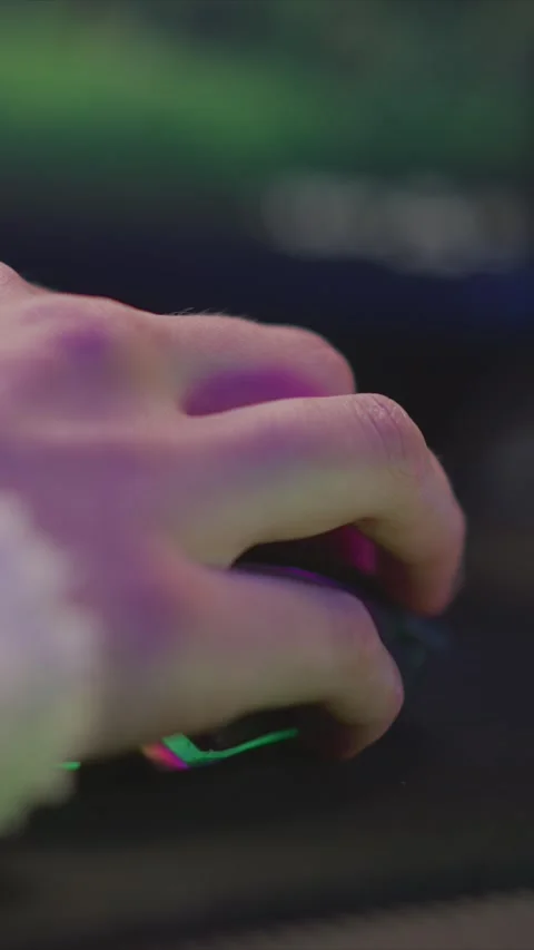 HAND MOVEMENT WITH GLOWING MOUSE UNDER SOFT PURPLE AND BLUE LIGHTING CLOSE UP Stock Footage 346769972
