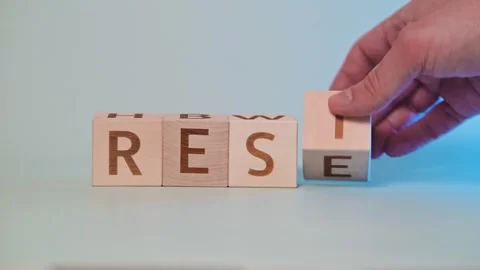A hand moves blocks with letters to form different words as the video progresses Stockbeeldmateriaal 338187622
