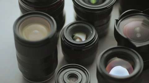 A hand moves the camera lens between other lenses. close up video tools of trade Video stock 128407377