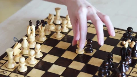 A hand moves a chess piece during a game, capturing an opponent's piece Stock Footage 278900407