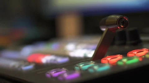 Hand moves a fader bar up on a video switcher panel Stock Footage