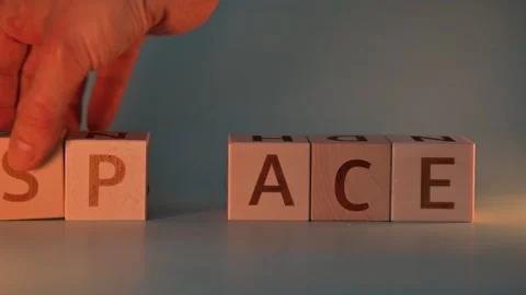 A hand moves letter blocks to change the words from peace to pace and then to Stock-Footage 338187692