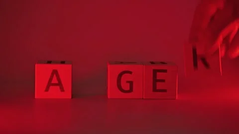 A hand moves letter blocks to form words related to strong emotions under red Stock Footage 338187706