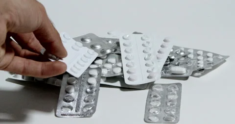 Hand moves to medication holders Stock Footage 197339084