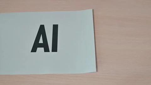 A hand moves paper sheets with the letters AI and VPN printed on them. This Stock Footage 338188247
