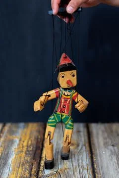 A hand moves the puppet Stock Photos