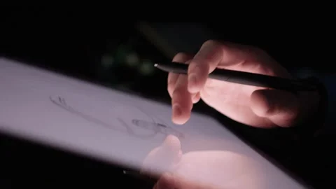 Hand moving a drawing on a touch pad at night Stock Footage 209661893