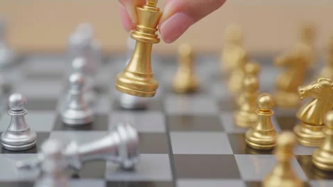 Hand moving gold Chess King figure and Checkmate opponent during chessboard.. Stock Footage 328070718