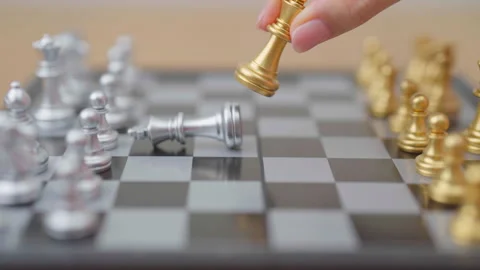 Hand moving gold Chess King figure and Checkmate opponent during chessboard.. Stock Footage 328070789