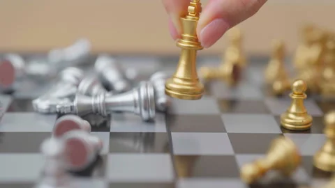 Hand moving gold Chess King figure and Checkmate opponent during chessboard.. Stock Footage 328071586