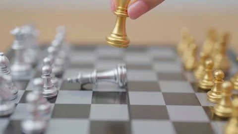 Hand moving gold Chess King figure and Checkmate opponent during chessboard.. Stock Footage 328071636
