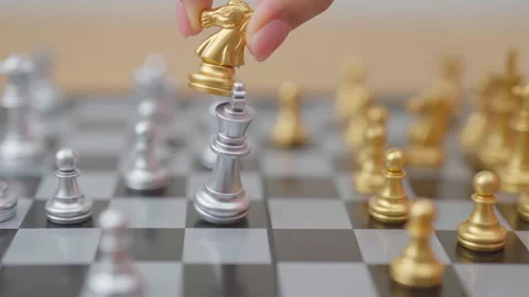 Hand moving gold Chess knight figure and Checkmate opponent during chessboa.. Stock Footage 327287058