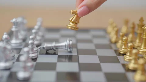 Hand moving gold Chess knight figure and Checkmate opponent during chessboa.. Stock Footage 327287463