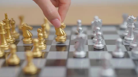 Hand moving gold Chess knight figure and Checkmate opponent during chessboa.. Stock Footage 328070670