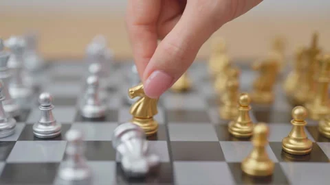 Hand moving gold Chess knight figure and Checkmate opponent during chessboa.. Stock Footage 328071591