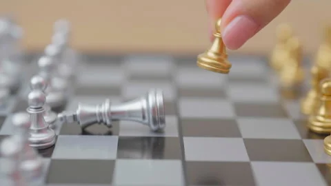 Hand moving gold Chess Pawn figure and Checkmate opponent during chessboard.. Stock Footage 328070660