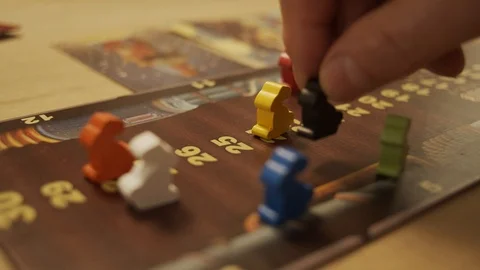 Hand moving hand pawn while playing board game on a table in shallow 스톡 동영상 119687003