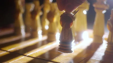 Hand moving handmade pawn chess piece on chessboard in backlight close-up. Stock Footage 149309434