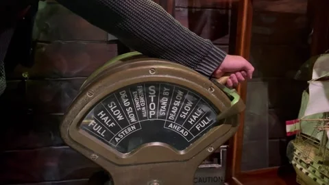 Hand moving an old ship engine order telegraph Stock Footage 236552692