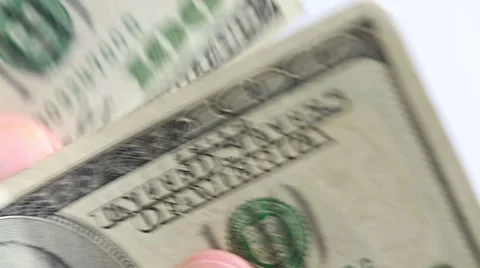 Hand moving through 100 dollar bills slowly Stock Footage 42244659