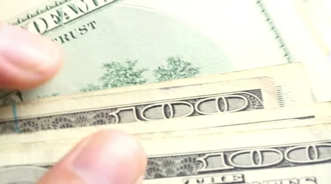 Hand moving through 100 dollar bills slowly Stock Footage 42244668
