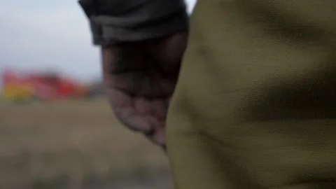 Hand in the mud ahead of the combine Stock Footage 141798413