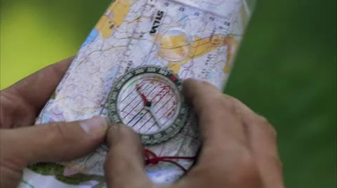 A hand navigates by the compass Stock Footage 11306551