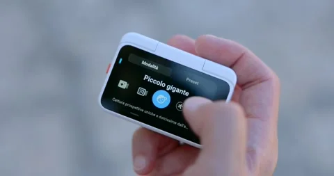 Hand navigating setting interface on Insta360 action pod screen Stock Footage 339105571