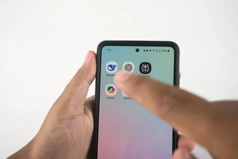 Hand Navigating Smartphone Apps Featuring AI-Themed Icons. Such as Deepseek.. Stock Photos