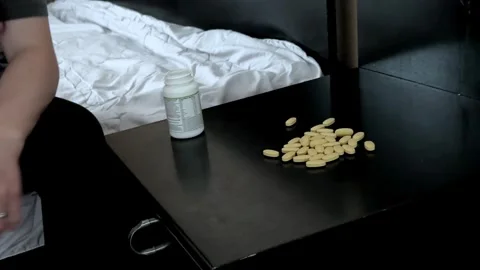 Hand Near Pill Bottle on Bedside Table Stock Footage 340340972