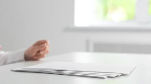 Hand Near Stack of Blank White Papers on Desk Stock Photos