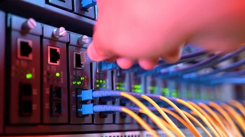 Hand with network cables connected to servers in datacenter Stock Footage 140590739