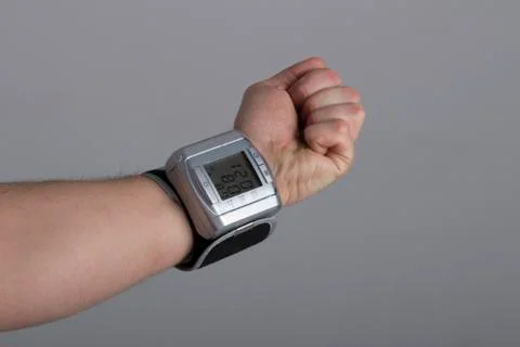 Hand with the new tonometer on grey background Stock Photos