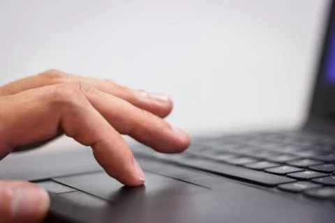 Hand on Notebook Touchpad Stock Photos