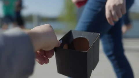 Hand offering coins to another hand as a gesture of generosity Stock Footage 307197113