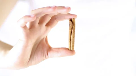 Hand Offering, showing cinnamon stick Stock Footage 34866072