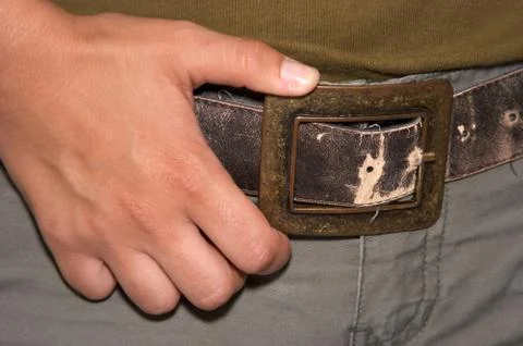 A hand on a old leather belt Stock Photos