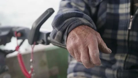 Hand of an old man on the control stick of a motor boat, Solina lake Stock Footage 237454813